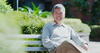 an older man sitting on a bench